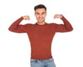 Smiling young man flexing his biceps Royalty Free Stock Photo