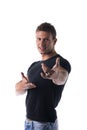 Smiling young man gesturing with his hands, pointing finger at you Royalty Free Stock Photo