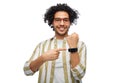 smiling young man in glasses showing smart watch Royalty Free Stock Photo