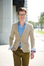 Smiling young man with glasses walking Royalty Free Stock Photo