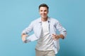 Smiling young man guy 20s in casual shirt posing isolated on pastel blue background studio portrait. People sincere Royalty Free Stock Photo