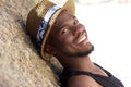 Smiling young man with hat relaxing outdoors Royalty Free Stock Photo