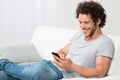 Smiling Young Man Holding Cellphone Royalty Free Stock Photo