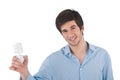 Smiling young man holding energy saving light bulb