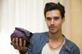 Smiling young man holding a fresh black cabbage in his hand
