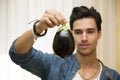 Smiling young man holding a fresh eggplant Royalty Free Stock Photo