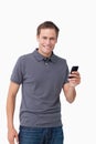Smiling young man holding his cellphone Royalty Free Stock Photo