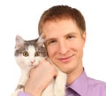 Smiling young man holds surprised cat isolated