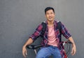 Smiling young man leaning with his bike against a wall Royalty Free Stock Photo