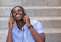 Smiling young man listening to music on headphones Royalty Free Stock Photo