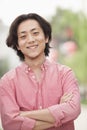 Smiling Young Man with Long Hair in Nanluoguxiang, Beijing, China