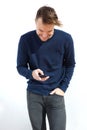 Smiling young man looking at mobile phone Royalty Free Stock Photo