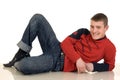 Smiling young man lying on the floor Royalty Free Stock Photo