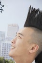 Smiling young man with Mohawk close-up, side view Royalty Free Stock Photo
