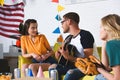 smiling young man playing guitar and looking at beautiful girl Royalty Free Stock Photo