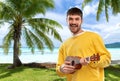 Smiling young man playing ukulele guitar Royalty Free Stock Photo