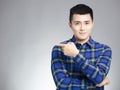 Smiling young man pointing copy space Royalty Free Stock Photo