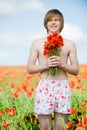 Smiling young man with poppies Royalty Free Stock Photo