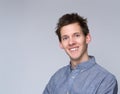 Smiling young man posing against gray background Royalty Free Stock Photo