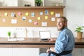 Smiling young man remote worker look at cam working from home office on laptop. Royalty Free Stock Photo