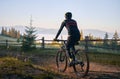 Smiling young man riding bicycle on mountain road. Royalty Free Stock Photo