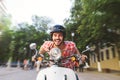 Smiling Young Man Riding Motor Scooter