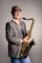 Smiling young man with a saxophone. Royalty Free Stock Photo