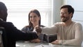 Smiling young man shaking hands with financial advisor. Royalty Free Stock Photo