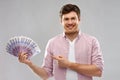 Smiling young man showing fan of euro money Royalty Free Stock Photo
