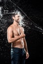 smiling young man showing thumb up while swilled with water