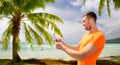 Smiling young man with smartphone and earphones Royalty Free Stock Photo