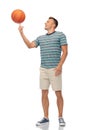 Smiling young man spinning ball on finger Royalty Free Stock Photo