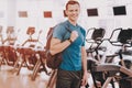 Smiling Young Man in Sport Club near Treadmills. Royalty Free Stock Photo