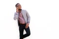 Smiling young man talking on mobile phone against white background Royalty Free Stock Photo