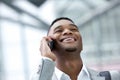 Smiling young man talking on mobile phone Royalty Free Stock Photo