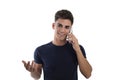 Smiling young man talking by phone mobile in a photo studio