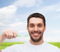 Smiling young man with toothbrush Royalty Free Stock Photo