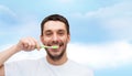 Smiling young man with toothbrush Royalty Free Stock Photo