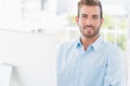 Smiling young man using computer in office Royalty Free Stock Photo