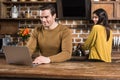 smiling young man using laptop while girlfriend Royalty Free Stock Photo