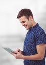 Smiling young man using tablet PC Royalty Free Stock Photo