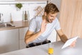 smiling young man waving by and and talking by digital tablet