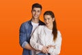 Smiling young man and woman in casual hugging during COVID-19 epidemic Royalty Free Stock Photo