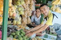 Smiling young man and woman sellers displaying assortment Royalty Free Stock Photo