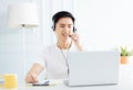 Smiling young man working from home with laptop Royalty Free Stock Photo