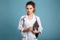 Smiling young medical nurse in uniform holding clipboard Royalty Free Stock Photo