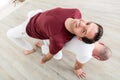 Man performing yoga pose with instructor Royalty Free Stock Photo