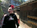 A smiling young miao woman walking in the village street