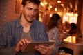 Smiling young millennial texting in restaurant Royalty Free Stock Photo