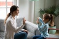 Smiling young woman teaching little cute girl sign language. Royalty Free Stock Photo